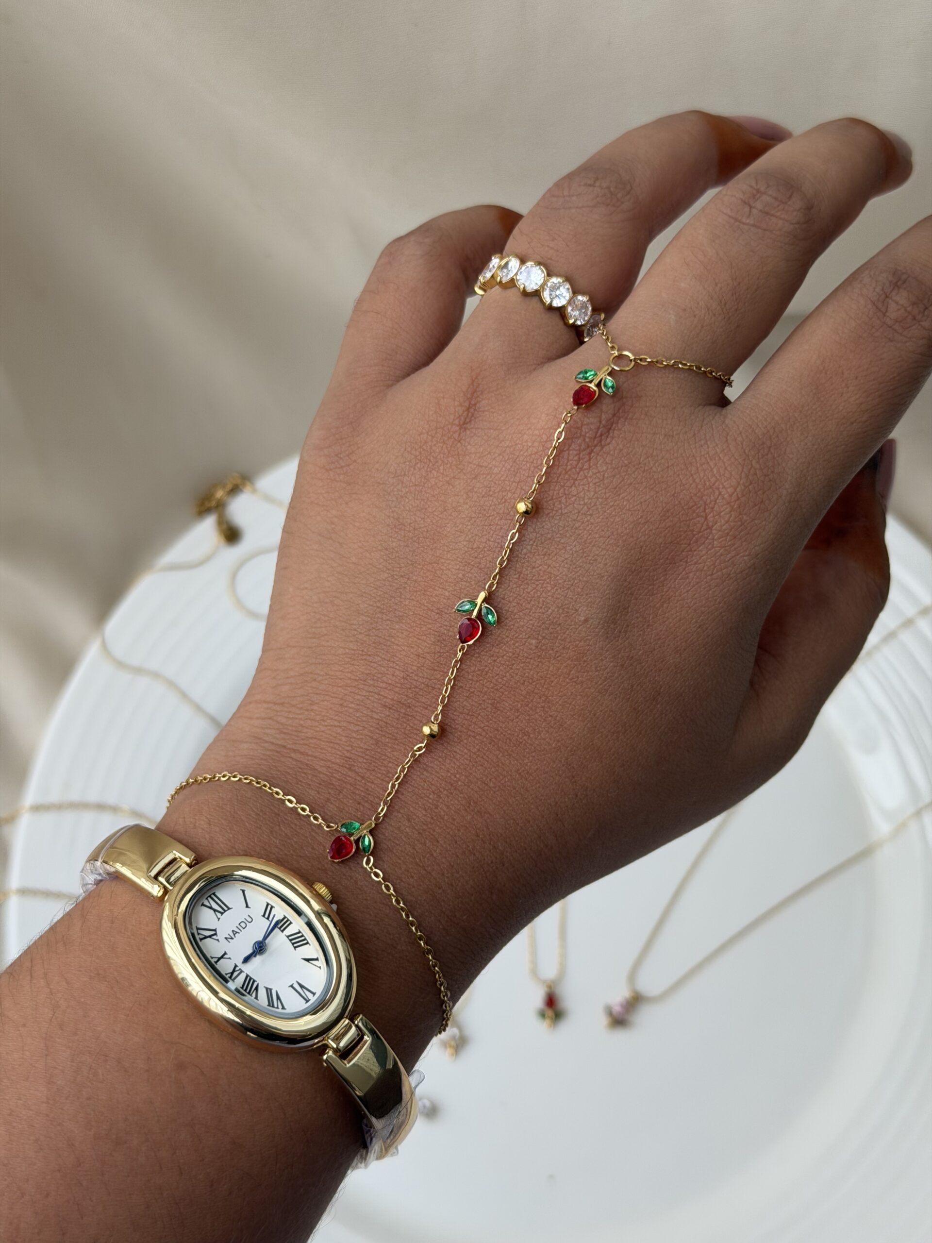 tulip hand chain jewellery for women, anti tarnish tulip hand chain in gold finish, elegant tulip hand chain with bracelet, waterproof gold hand chain for women, delicate tulip hand chain jewellery, stylish gold hand chain for festive occasions, trendy tulip hand chain accessory, modern anti tarnish hand chain, beautiful gold tulip hand chain, traditional hand chain jewellery with tulip design